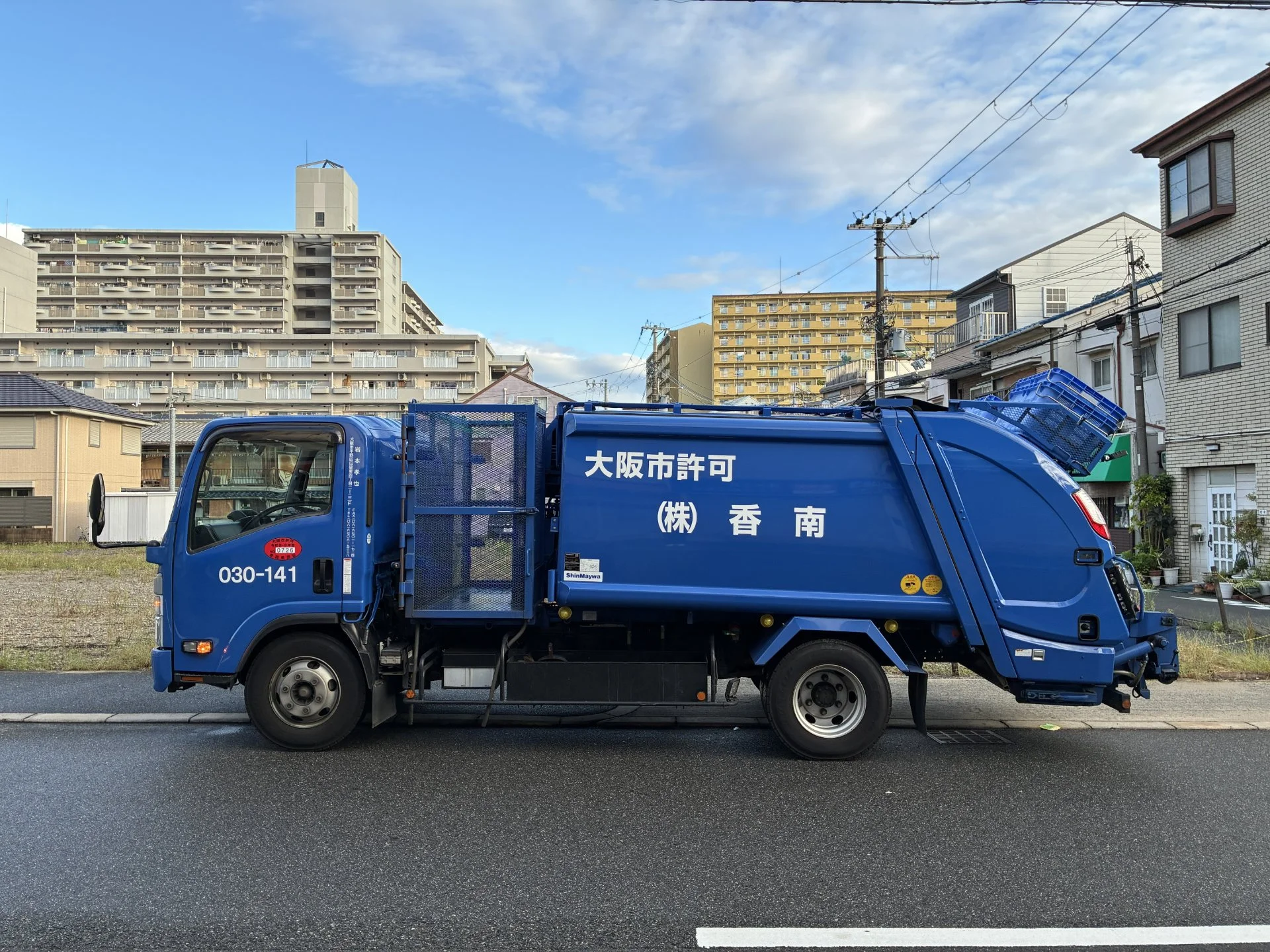 大阪市許可の表記がある株式会社　香南の青い収集車